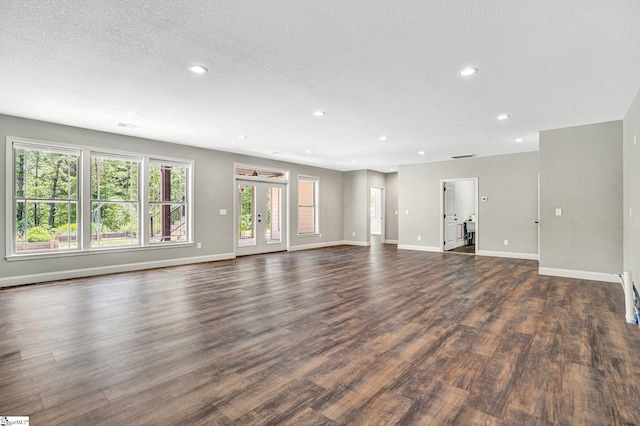1061 Hidden Glory Dr, Landrum, SC 29356 - unfurnished living room with dark wood-style floors, baseboards, recessed lighting, plenty of natural light, and a textured ceiling