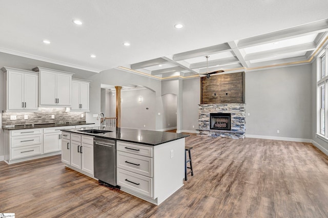 1061 Hidden Glory Dr, Landrum, SC 29356 - kitchen featuring a sink, decorative columns, dark countertops, a center island with sink, and coffered ceiling