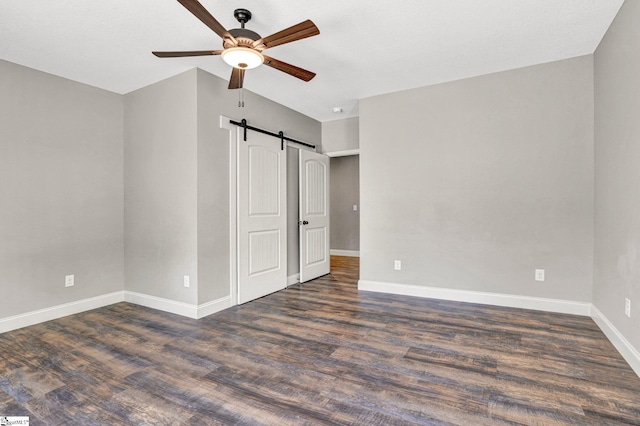 1061 Hidden Glory Dr, Landrum, SC 29356 - unfurnished bedroom with wood finished floors, baseboards, a barn door, and ceiling fan