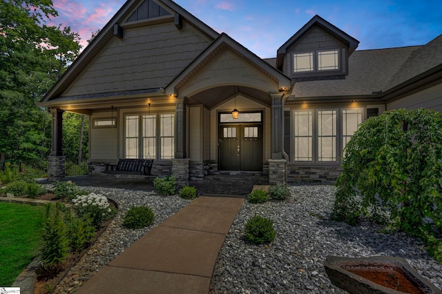 1061 Hidden Glory Dr, Landrum, SC 29356 - view of front of home with a porch, stone siding, and roof with shingles