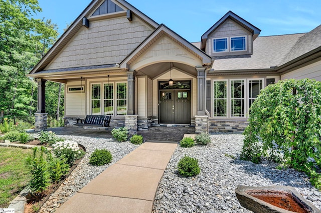 1061 Hidden Glory Dr, Landrum, SC 29356 - doorway to property with a porch, stone siding, and a shingled roof
