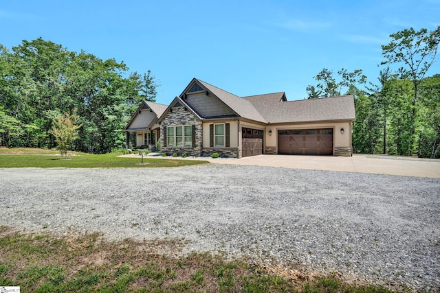 1061 Hidden Glory Dr, Landrum, SC 29356 - craftsman-style house with stone siding, a garage, driveway, and a front lawn