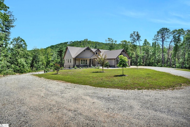 1061 Hidden Glory Dr, Landrum, SC 29356 - single story home featuring curved driveway, a front lawn, and a view of trees