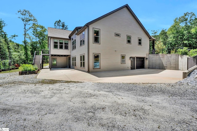 1061 Hidden Glory Dr, Landrum, SC 29356 - back of house featuring an attached garage and a patio area