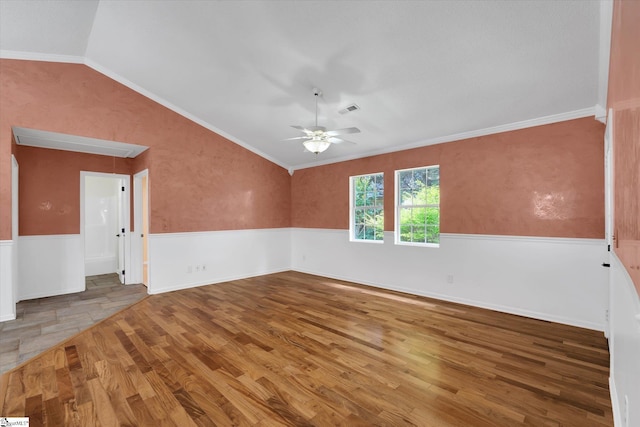 1783 Brockman Mcclimon Rd, Greer, SC 29651 - empty room featuring a ceiling fan, vaulted ceiling, wood finished floors, a wainscoted wall, and ornamental molding