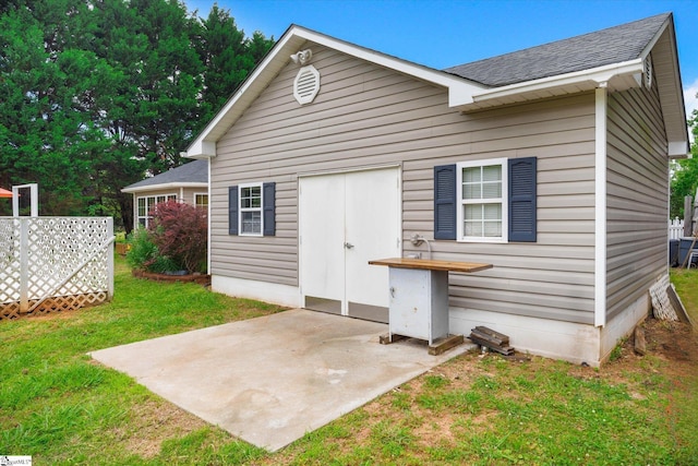 1783 Brockman Mcclimon Rd, Greer, SC 29651 - rear view of house featuring a patio, roof with shingles, and a yard