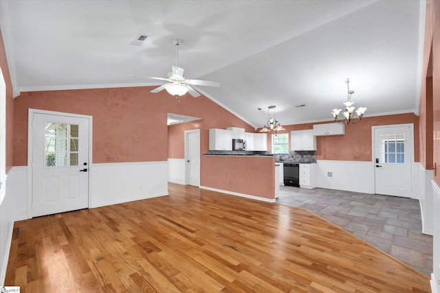 1783 Brockman Mcclimon Rd, Greer, SC 29651 - unfurnished living room featuring a chandelier, a wainscoted wall, lofted ceiling, healthy amount of natural light, and ceiling fan