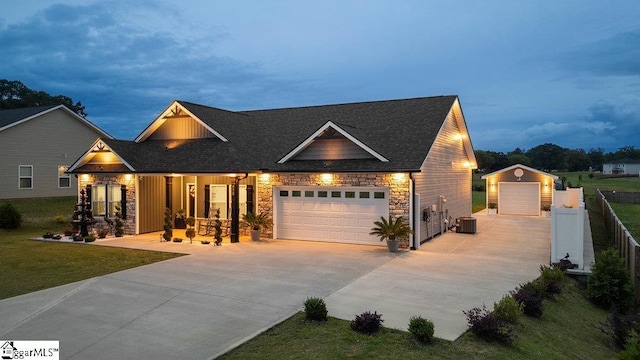 223 R C Thompson Rd, Chesnee, SC 29323 - view of front of home featuring stone siding, concrete driveway, central air condition unit, and roof with shingles