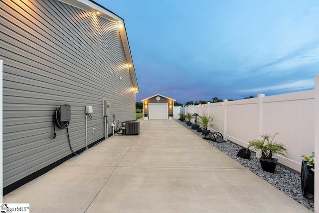 223 R C Thompson Rd, Chesnee, SC 29323 - view of patio featuring central air condition unit, an outbuilding, a detached garage, and concrete driveway