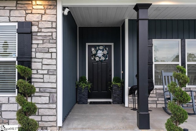 223 R C Thompson Rd, Chesnee, SC 29323 - view of exterior entry with stone siding, a porch, and board and batten siding