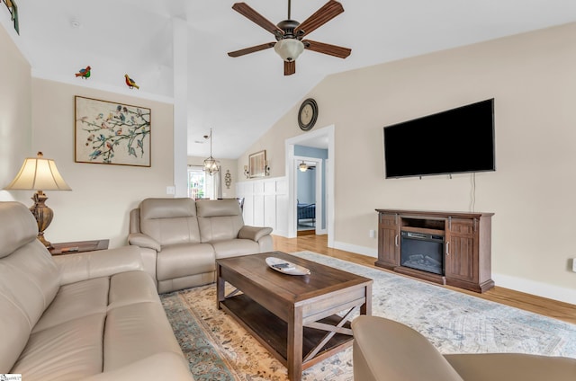 7 Slate Ln, Greer, SC 29650 - living room featuring a ceiling fan, vaulted ceiling, wood finished floors, baseboards, and a glass covered fireplace