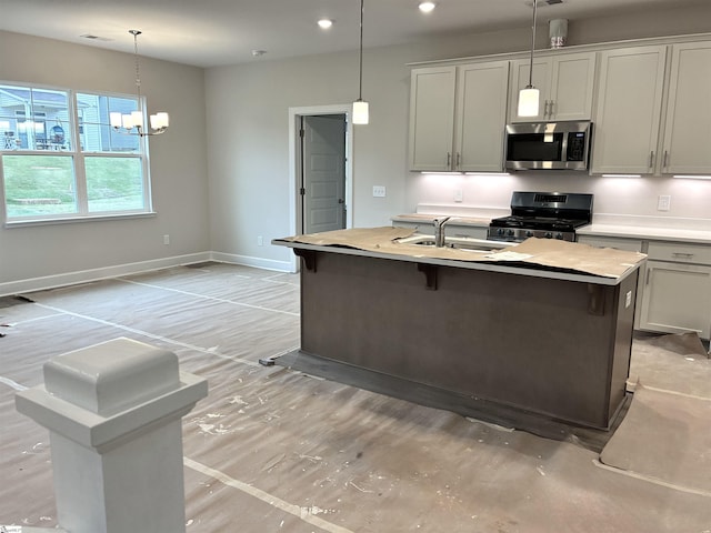 213 Fenner Pl, Greenville, SC 29607 - kitchen with stainless steel appliances, a sink, a center island with sink, recessed lighting, and pendant lighting