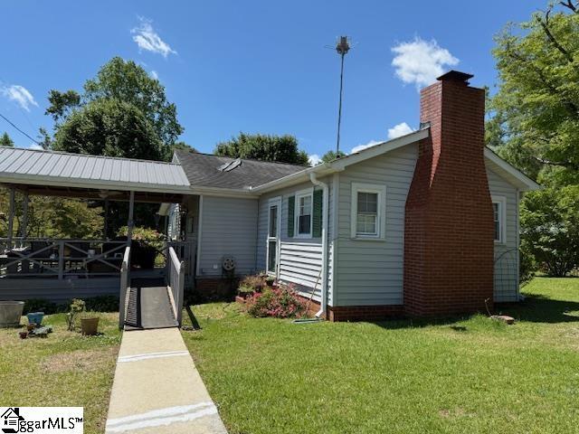 3444 Geer Hwy, Marietta, SC 29661 - single story home featuring a front lawn and a chimney