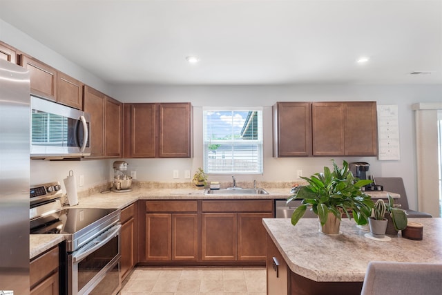 841 Speakeasy Ln, Inman, SC 29349 - kitchen featuring stainless steel appliances, a sink, light countertops, recessed lighting, and brown cabinetry