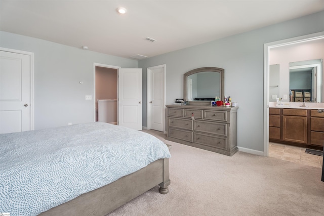 841 Speakeasy Ln, Inman, SC 29349 - bedroom featuring light carpet, a sink, ensuite bath, and baseboards