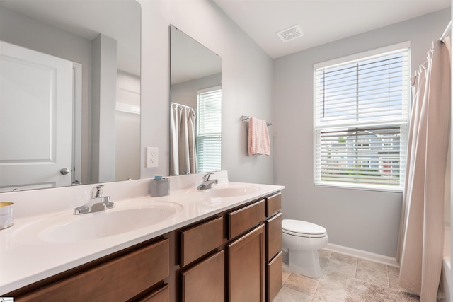 841 Speakeasy Ln, Inman, SC 29349 - full bath with double vanity, baseboards, healthy amount of natural light, and toilet