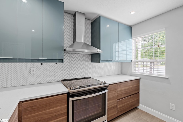 3 Alewine Ct, Taylors, SC 29687 - kitchen featuring stainless steel electric stove, wall chimney range hood, tasteful backsplash, plenty of natural light, and recessed lighting