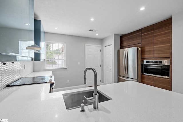 3 Alewine Ct, Taylors, SC 29687 - kitchen featuring appliances with stainless steel finishes, recessed lighting, a sink, modern cabinets, and wall chimney range hood