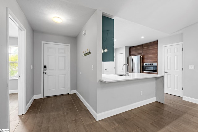 3 Alewine Ct, Taylors, SC 29687 - kitchen featuring stainless steel appliances, a sink, light countertops, baseboards, and modern cabinets