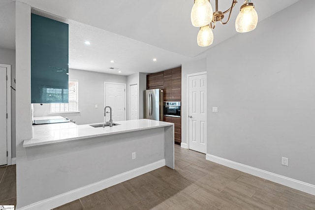 3 Alewine Ct, Taylors, SC 29687 - kitchen with a sink, stainless steel appliances, baseboards, light countertops, and a peninsula
