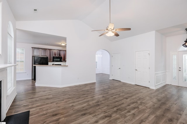 16 Glenbow Ct, Simpsonville, SC 29680 - unfurnished living room featuring a ceiling fan, dark wood-style floors, arched walkways, high vaulted ceiling, and a fireplace with flush hearth