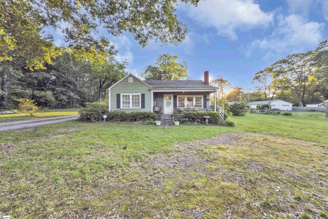 2413 Andrews Rd, Spartanburg, SC 29302 - view of front facade with covered porch, a chimney, and a front lawn