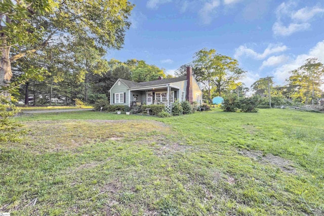 2413 Andrews Rd, Spartanburg, SC 29302 - view of property exterior featuring a porch, a chimney, and a yard