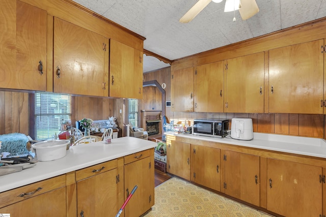 2413 Andrews Rd, Spartanburg, SC 29302 - kitchen with light countertops, brown cabinetry, healthy amount of natural light, and wooden walls
