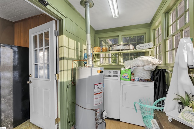 2413 Andrews Rd, Spartanburg, SC 29302 - laundry area with water heater, washer and clothes dryer, wood finished floors, wood walls, and ornamental molding