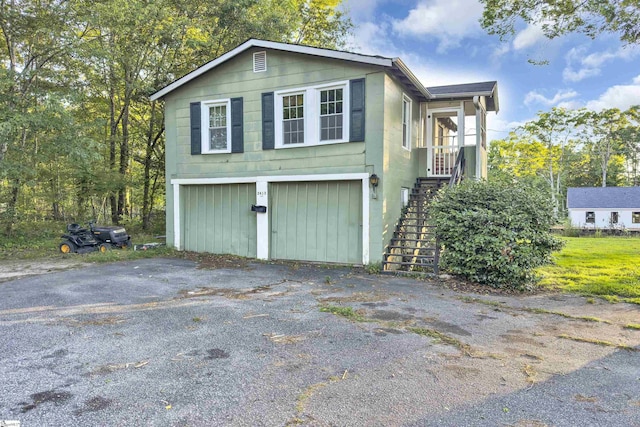 2413 Andrews Rd, Spartanburg, SC 29302 - view of side of property with stairway, asphalt driveway, and an attached garage
