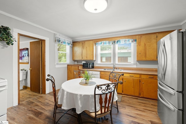 1 Baldwin St, Pelzer, SC 29669 - kitchen featuring appliances with stainless steel finishes, light countertops, a sink, light wood-style floors, and brown cabinets
