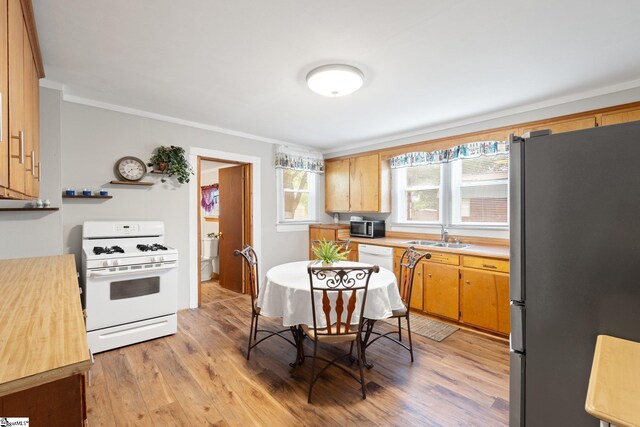 1 Baldwin St, Pelzer, SC 29669 - kitchen featuring appliances with stainless steel finishes, light countertops, light wood-style floors, a sink, and ornamental molding