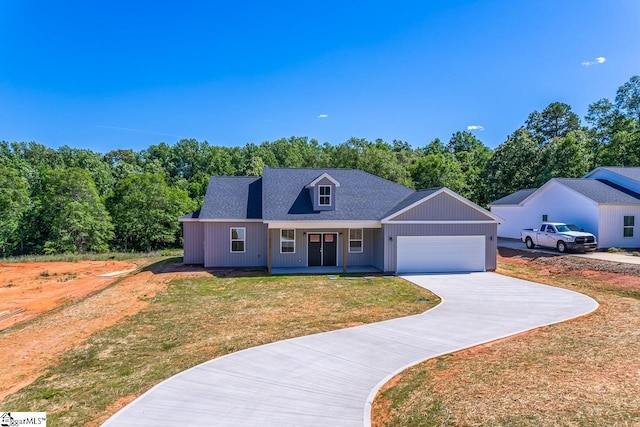 411 Wyatt Rd, Piedmont, SC 29673 - view of front of property featuring a front yard, driveway, an attached garage, a porch, and a shingled roof