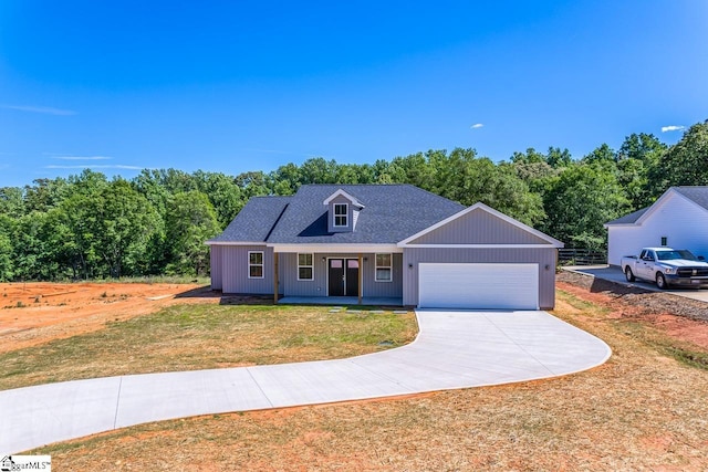 411 Wyatt Rd, Piedmont, SC 29673 - view of front facade with a garage, a front lawn, driveway, a porch, and a shingled roof