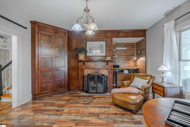 251 W Mcelhaney Rd, Taylors, SC 29687 - living area with wood finished floors, wood walls, a brick fireplace, baseboards, and stairs