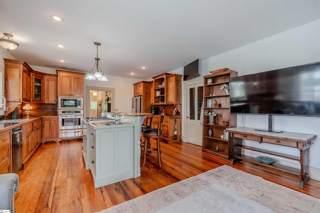 251 W Mcelhaney Rd, Taylors, SC 29687 - kitchen with appliances with stainless steel finishes, open shelves, a warming drawer, light wood finished floors, and brown cabinets