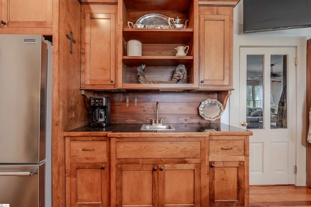 251 W Mcelhaney Rd, Taylors, SC 29687 - kitchen featuring freestanding refrigerator, a sink, dark countertops, open shelves, and wood finished floors