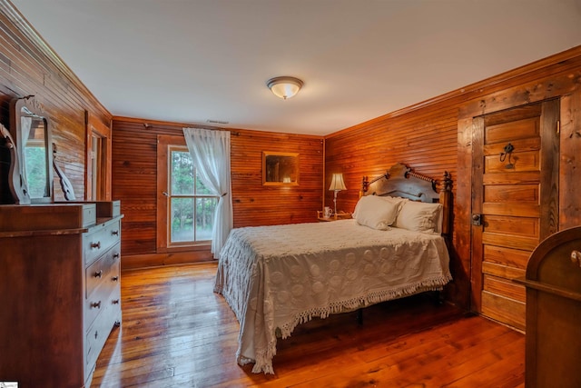 251 W Mcelhaney Rd, Taylors, SC 29687 - bedroom featuring wooden walls, hardwood / wood-style floors, and crown molding