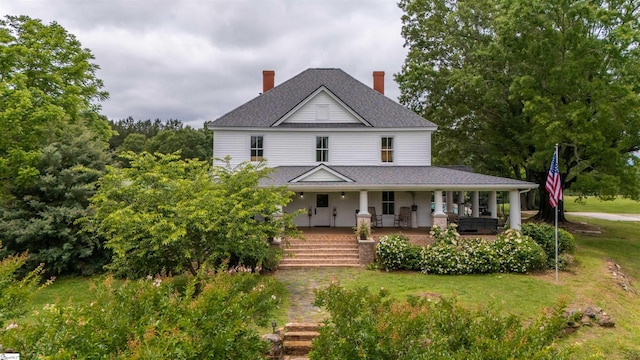 251 W Mcelhaney Rd, Taylors, SC 29687 - country-style home with a front yard, roof with shingles, covered porch, and a chimney