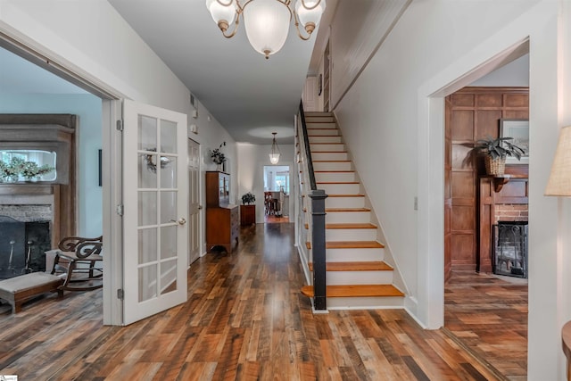 251 W Mcelhaney Rd, Taylors, SC 29687 - foyer entrance featuring a stone fireplace, wood finished floors, stairway, and a chandelier