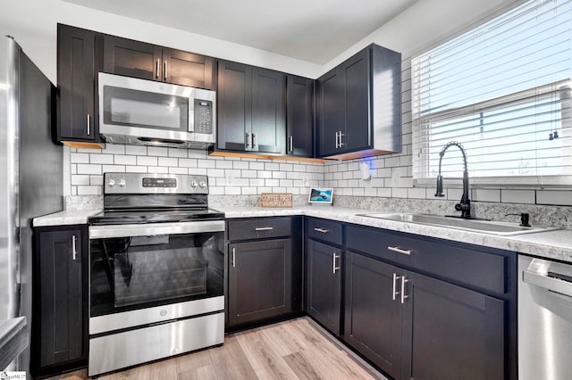 709 Bolsover Way, Woodruff, SC 29388 - kitchen with appliances with stainless steel finishes, a sink, light countertops, and tasteful backsplash