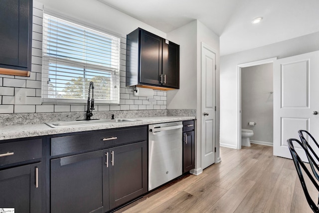 709 Bolsover Way, Woodruff, SC 29388 - kitchen featuring stainless steel dishwasher, a sink, light wood-type flooring, decorative backsplash, and light countertops