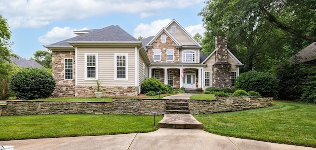 116 Legends Way, Simpsonville, SC 29681 - view of front of house featuring stone siding, a porch, a front lawn, and a chimney