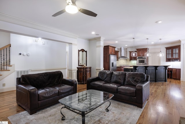 116 Legends Way, Simpsonville, SC 29681 - living room with light wood-type flooring, a ceiling fan, stairs, recessed lighting, and crown molding
