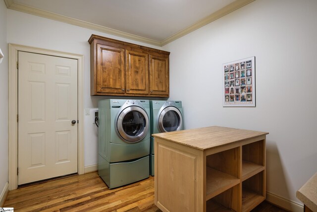 116 Legends Way, Simpsonville, SC 29681 - laundry area with crown molding, separate washer and dryer, cabinet space, light wood-style floors, and baseboards