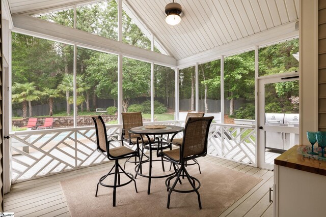 116 Legends Way, Simpsonville, SC 29681 - sunroom with lofted ceiling, outdoor dining space, plenty of natural light, and view of scattered trees