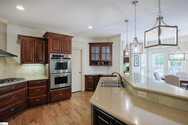 116 Legends Way, Simpsonville, SC 29681 - kitchen with a sink, stainless steel appliances, light wood-style flooring, light stone countertops, and decorative backsplash