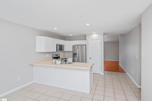 106 Felix Ct, Easley, SC 29640 - kitchen featuring stainless steel appliances, light countertops, a peninsula, light tile patterned flooring, and recessed lighting