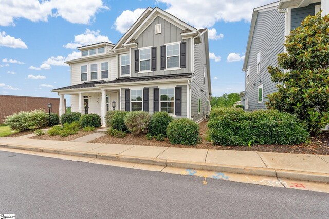 113 Noble St, Greer, SC 29651 - view of property featuring board and batten siding, a porch, a standing seam roof, and metal roof