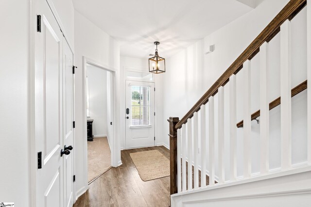 113 Noble St, Greer, SC 29651 - entryway with wood finished floors, a chandelier, baseboards, and stairs